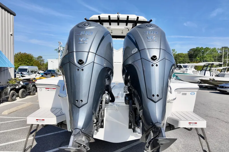Slide: The Image of Twin Yamaha 300 V6 engines on a 2026 Sea Fox 282 Hybrid LT boat, parked outdoors. - 5