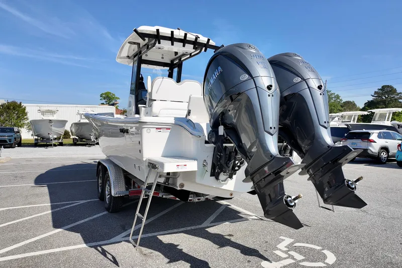 Slide: The Image of 2026 Sea Fox 282 Hybrid LT boat with dual Yamaha outboard engines in a parking lot. - 9