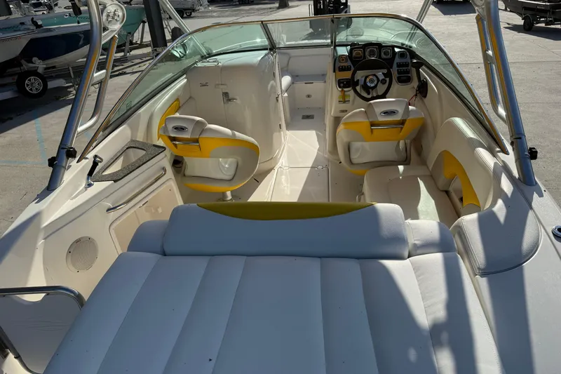 Slide: The Image of 2008 Chaparral 236 SSX boat interior with yellow and white seating, steering wheel, and dashboard. - 10
