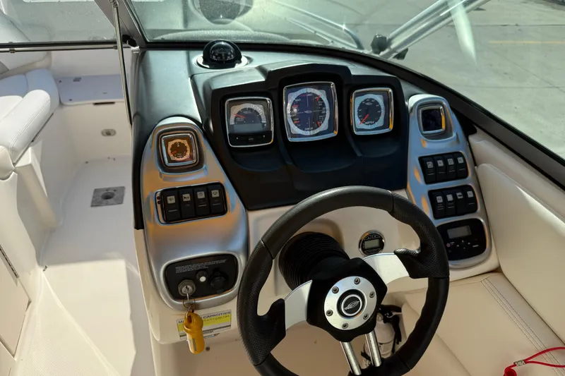 Slide: The Image of 2008 Chaparral 236 SSX boat dashboard with steering wheel and instrument panel. - 13