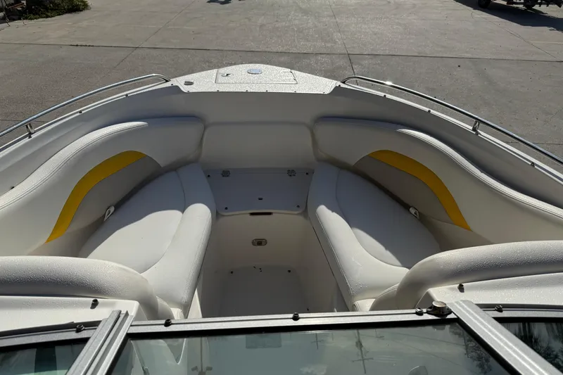 Slide: The Image of 2008 Chaparral 236 SSX boat interior with white and yellow seating. - 14