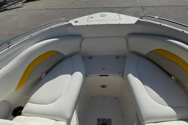Slide: The Image of 2008 Chaparral 236 SSX boat interior with white and yellow seating. - 15