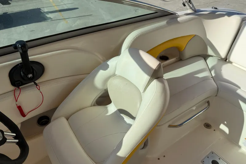 Slide: The Image of 2008 Chaparral 236 SSX boat interior with white seating and steering wheel. - 16