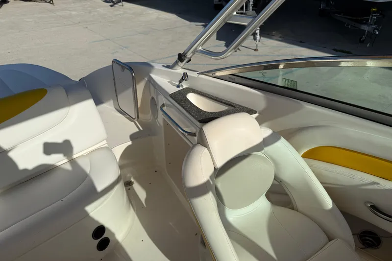 Slide: The Image of 2008 Chaparral 236 SSX boat interior with white seating and yellow accents. - 17