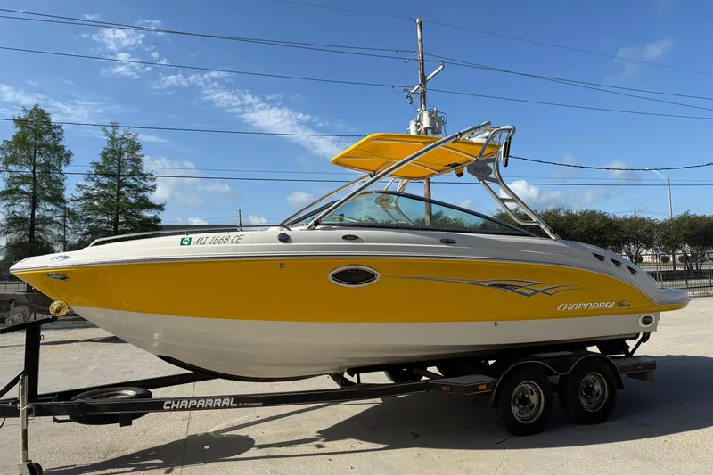 Slide: The Image of 2008 Chaparral 236 SSX boat with yellow and white exterior on trailer. - 6