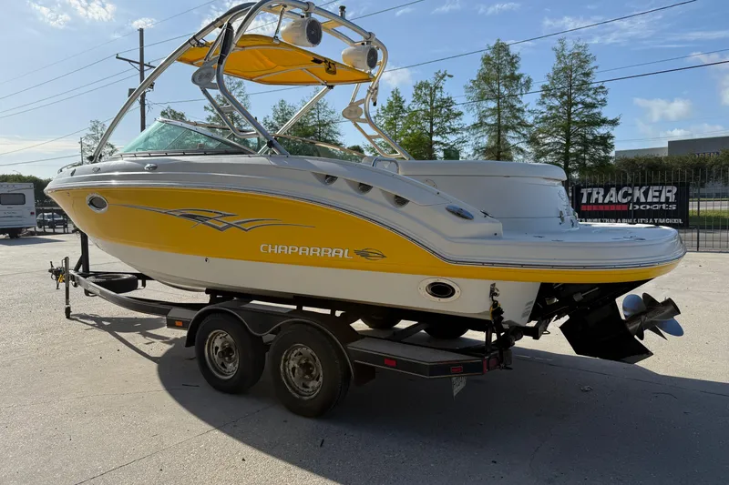 Slide: The Image of 2008 Chaparral 236 SSX boat with yellow and white exterior on a trailer. - 7