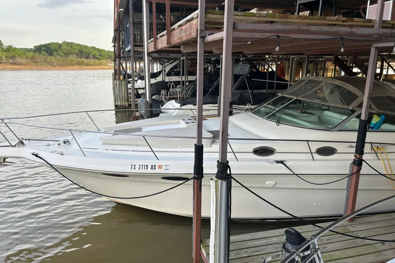 Slide: The Image of 1997 Sea Ray Sundancer 330 docked at a marina, side view. - 13