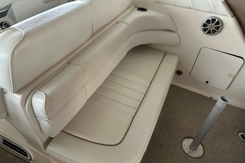 Slide: The Image of 1997 Sea Ray Sundancer 330 interior with beige seating and speaker detail. - 16