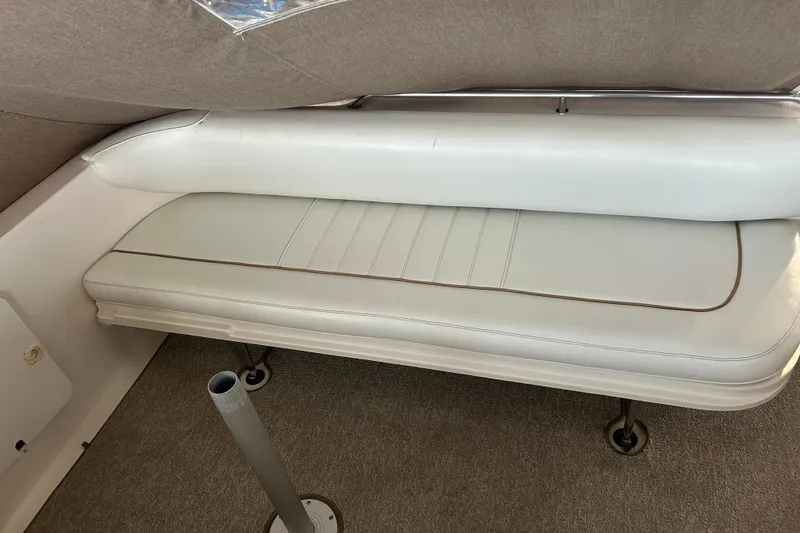 Slide: The Image of 1997 Sea Ray Sundancer 330 interior seating with white upholstery and carpeted flooring. - 17