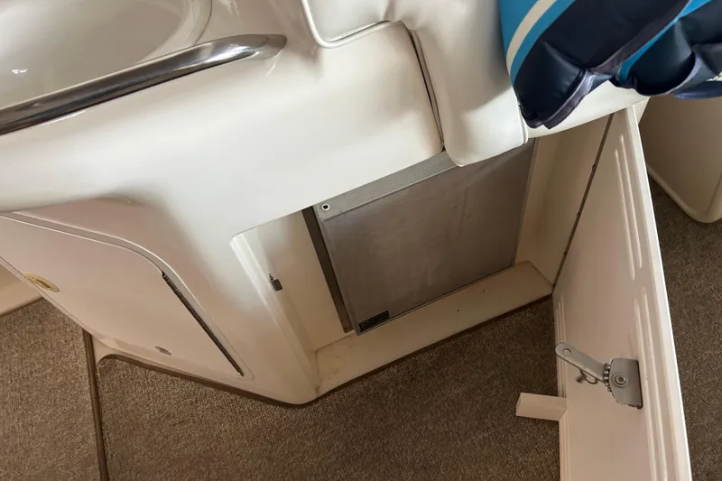 Slide: The Image of Interior view of a 1997 Sea Ray Sundancer 330 boat, featuring a storage compartment. - 19