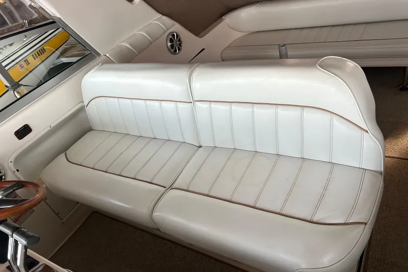 Slide: The Image of 1997 Sea Ray Sundancer 330 interior with white leather seating and wood accents. - 20