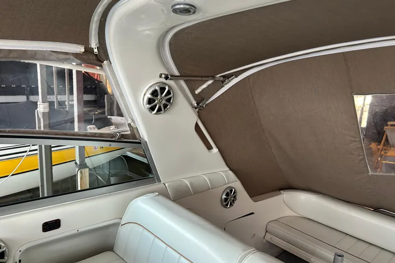 Slide: The Image of Interior of a 1997 Sea Ray Sundancer 330 boat with beige upholstery and speakers. - 21