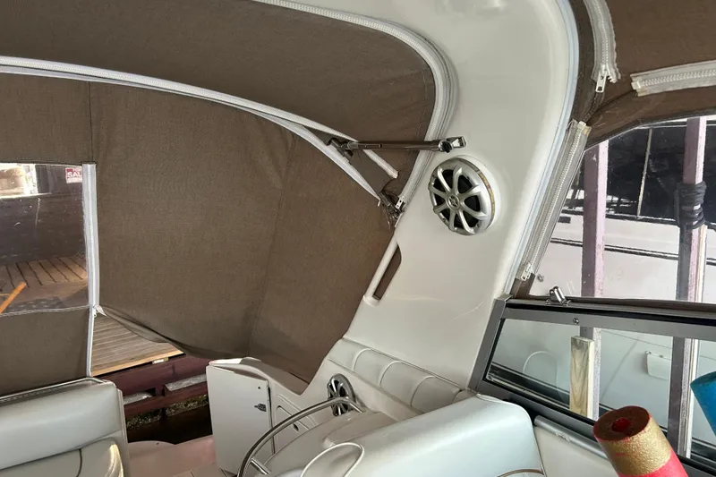 Slide: The Image of Interior of a 1997 Sea Ray Sundancer 330 boat with brown canvas and speaker. - 22