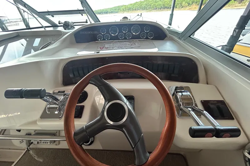 Slide: The Image of 1997 Sea Ray Sundancer 330 helm with wooden steering wheel and control panel. - 24