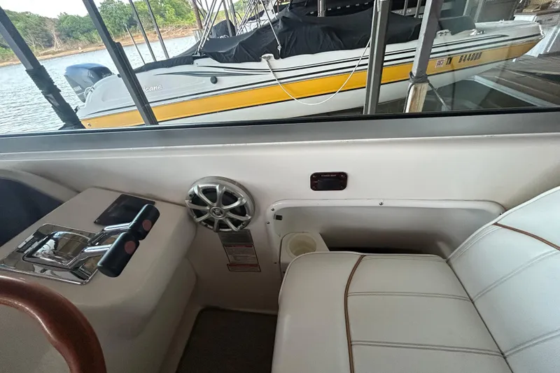 Slide: The Image of Interior view of a 1997 Sea Ray Sundancer 330 boat with control panel and seating. - 25