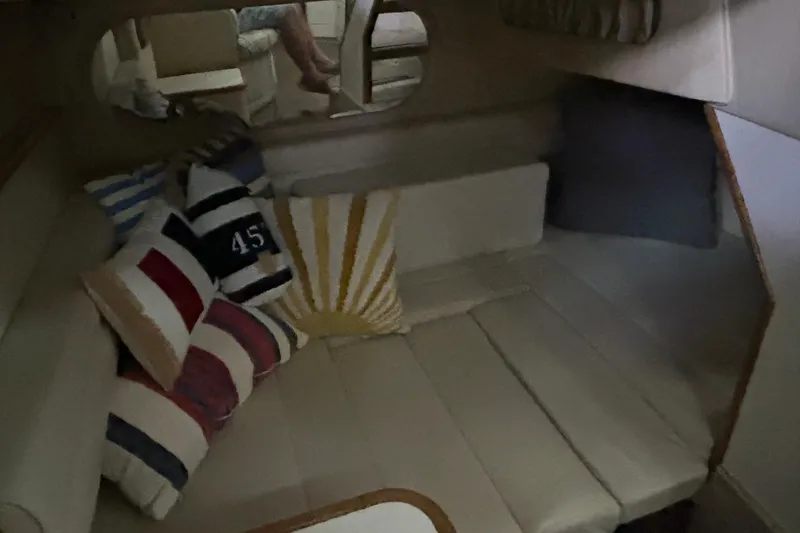 Slide: The Image of Interior of 1997 Sea Ray Sundancer 330 with striped cushions and cozy seating area. - 27