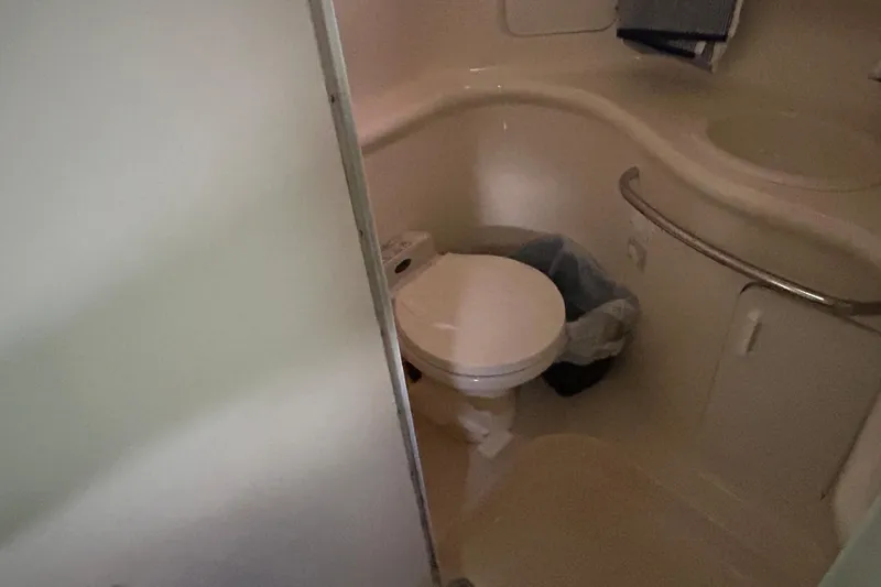 Slide: The Image of Bathroom interior of 1997 Sea Ray Sundancer 330 yacht, featuring toilet and sink. - 32