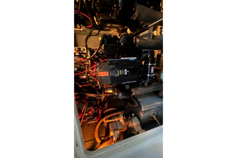 Slide: The Image of Engine compartment of a 1997 Sea Ray Sundancer 330 with visible wiring and components. - 36