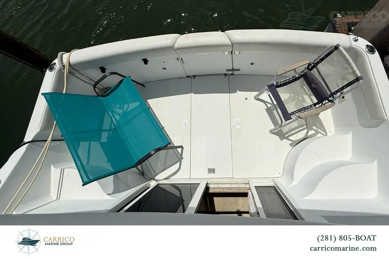 Slide: The Image of 2000 Carver 350 Mariner boat deck with chairs, docked at Carrico Marine Group. - 10