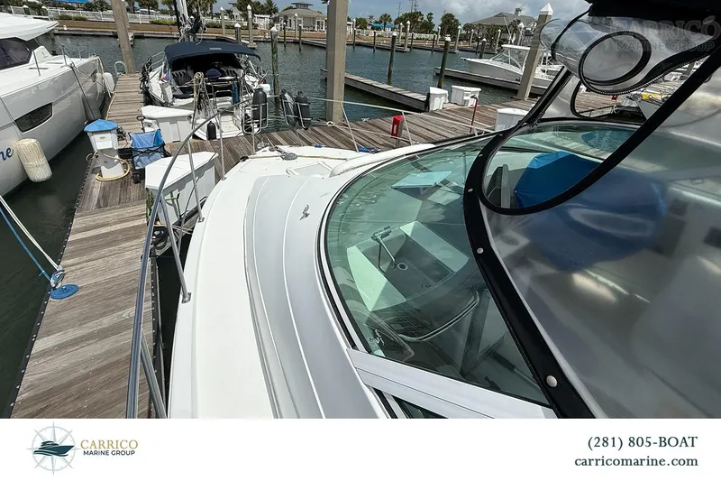 Slide: The Image of 2000 Carver 350 Mariner docked at marina, showcasing sleek design and spacious deck. - 11