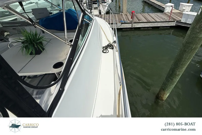 Slide: The Image of 2000 Carver 350 Mariner yacht docked at marina, featuring sleek design and spacious deck. - 12