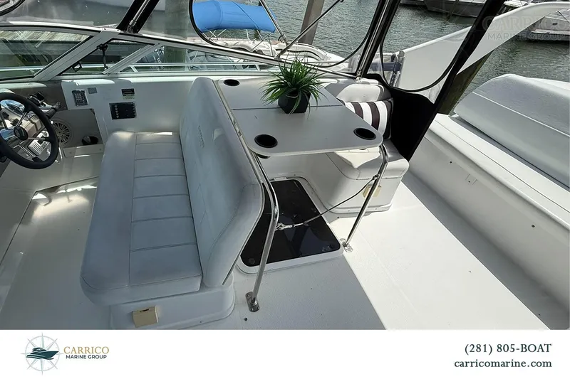 Slide: The Image of Interior of a 2000 Carver 350 Mariner boat with seating and table. - 16