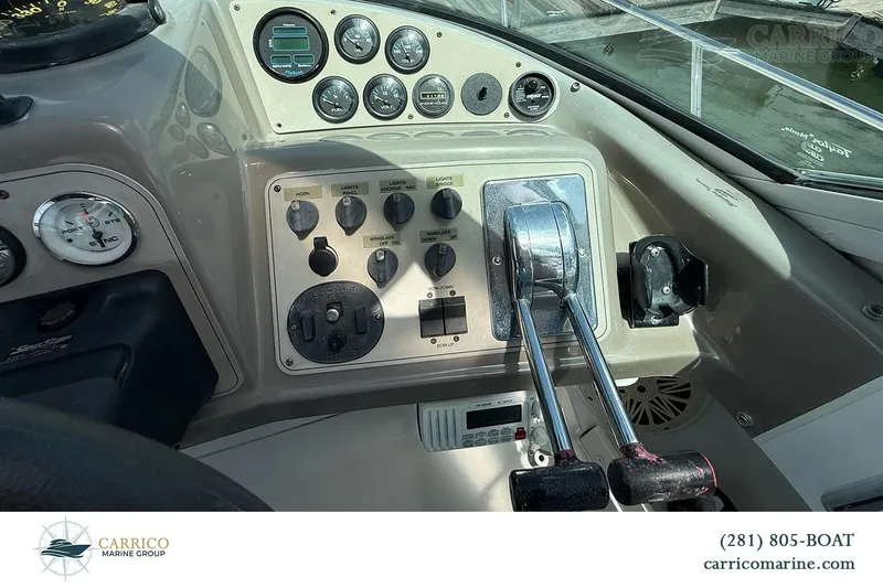 Slide: The Image of Control panel of a 2000 Carver 350 Mariner boat with gauges and throttle levers. - 20
