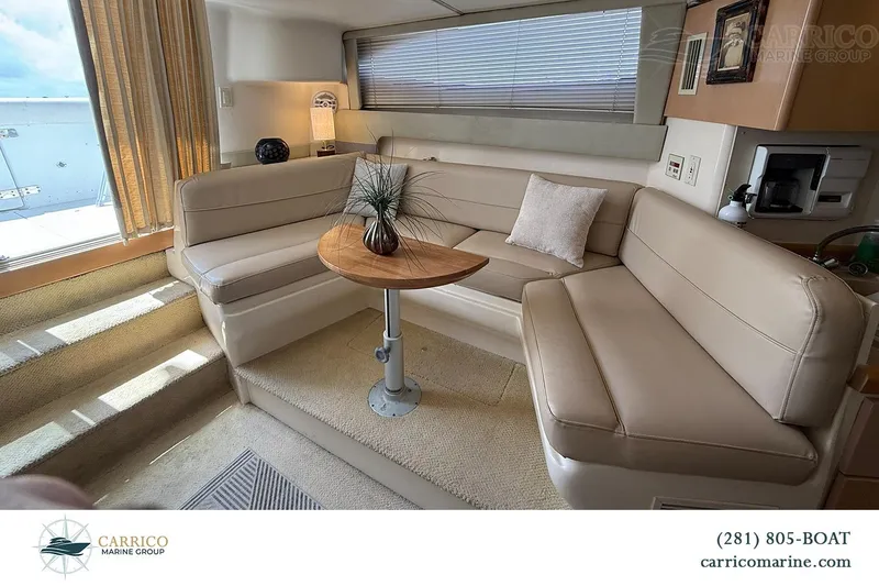 Slide: The Image of Interior of 2000 Carver 350 Mariner yacht with beige seating and wooden table. - 23