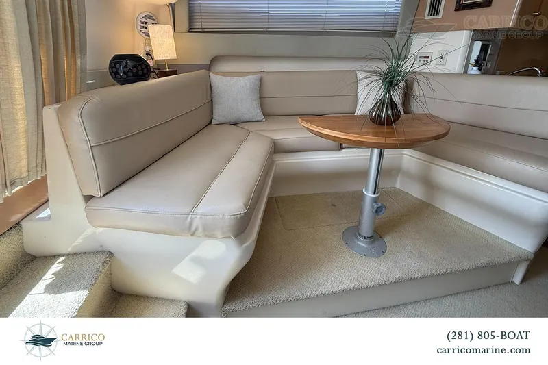 Slide: The Image of Interior of 2000 Carver 350 Mariner yacht with beige seating and wooden table. - 24