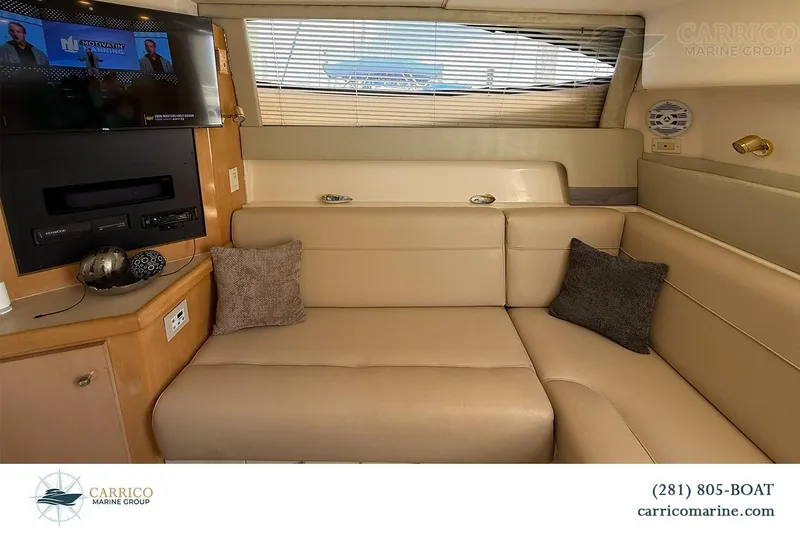 Slide: The Image of Interior of 2000 Carver 350 Mariner yacht with beige seating and entertainment system. - 25