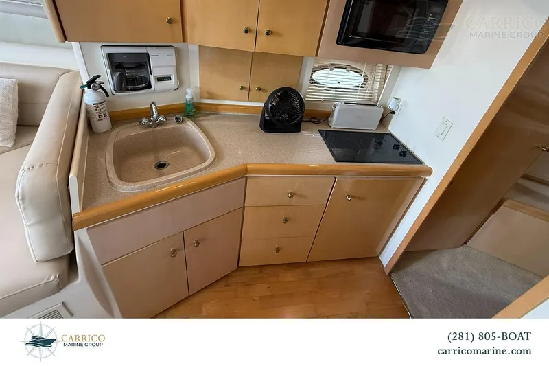 Slide: The Image of Compact kitchen area in a 2000 Carver 350 Mariner yacht with sink and stove. - 28