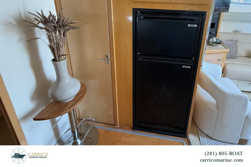 Slide: The Image of Interior of a 2000 Carver 350 Mariner yacht with a vase and compact fridge. - 29
