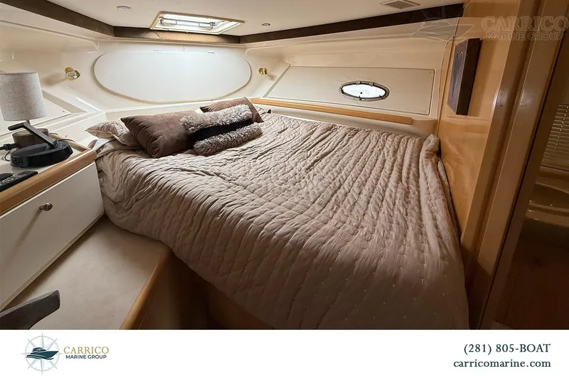 Slide: The Image of Luxurious cabin interior of 2000 Carver 350 Mariner yacht with cozy bedding. - 30