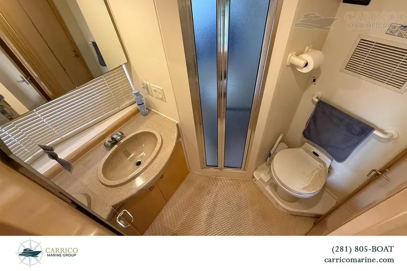 Slide: The Image of Bathroom interior of 2000 Carver 350 Mariner yacht with sink, toilet, and shower. - 32