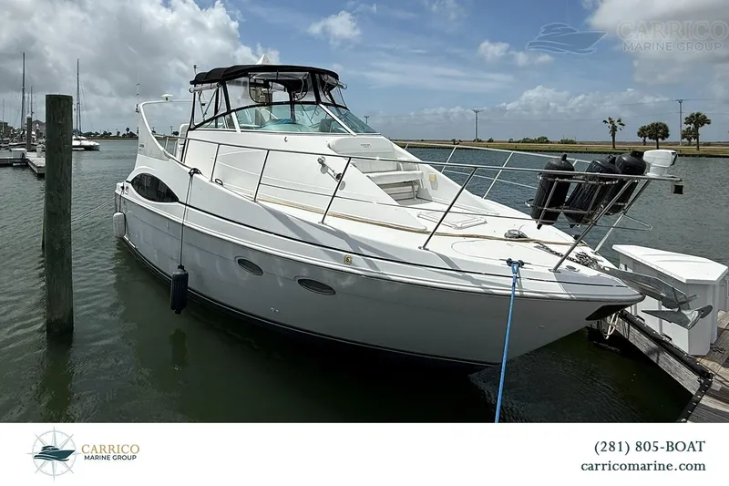 Slide: The Image of 2000 Carver 350 Mariner yacht docked at marina under cloudy sky. - 4