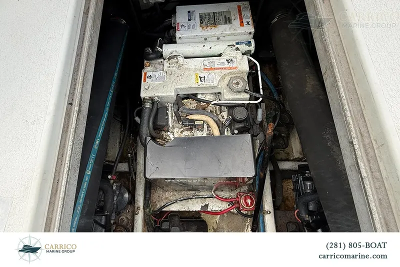 Slide: The Image of Engine compartment of a 2000 Carver 350 Mariner boat, showcasing mechanical components. - 42
