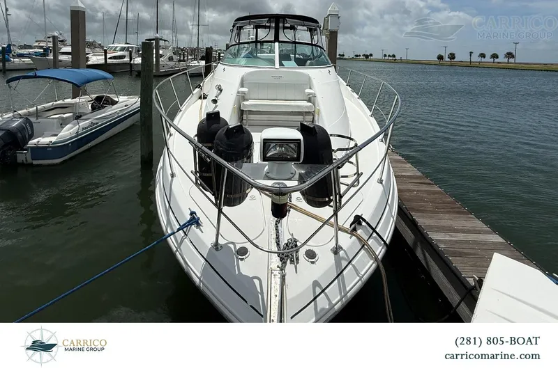 Slide: The Image of 2000 Carver 350 Mariner yacht docked at marina, featuring sleek design and spacious deck. - 5