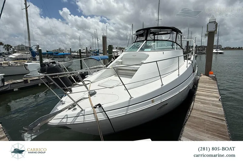 Slide: The Image of 2000 Carver 350 Mariner yacht docked at marina under cloudy sky. - 6
