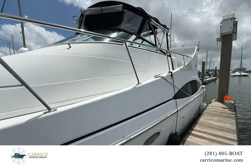 Slide: The Image of 2000 Carver 350 Mariner yacht docked at marina under cloudy sky. - 7