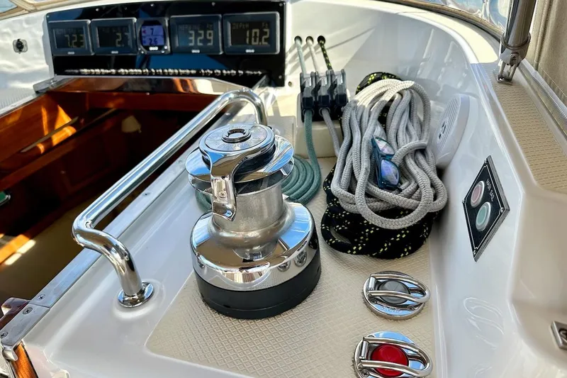 Slide: The Image of Cockpit of 2012 Hylas 56 yacht with winch, ropes, and navigation instruments. - 19
