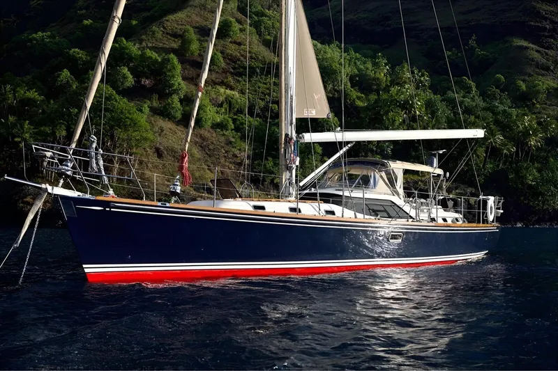 Slide: The Image of Sailing yacht Hylas 56, 2012 model, anchored near lush green hills. - 2