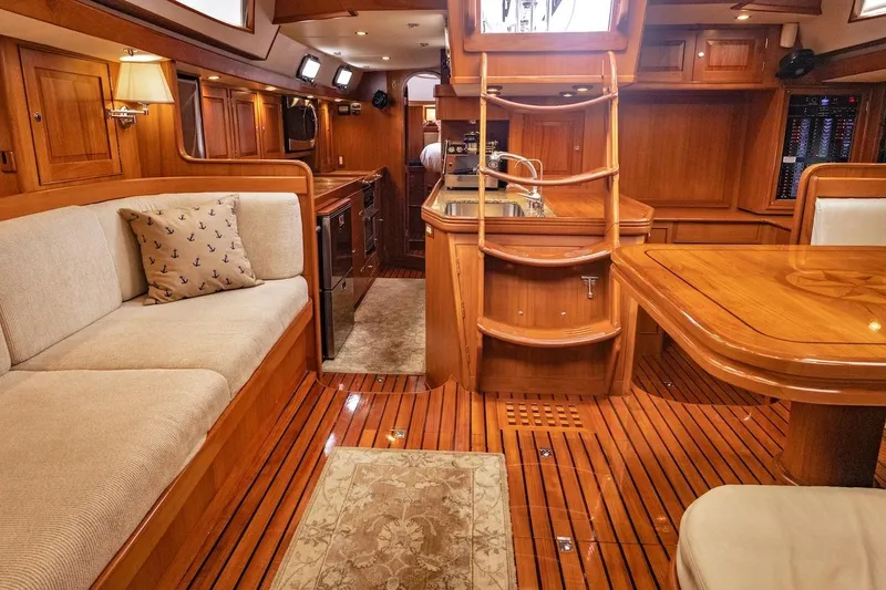 Slide: The Image of Luxurious 2012 Hylas 56 yacht interior with wooden finishes and cozy seating area. - 21