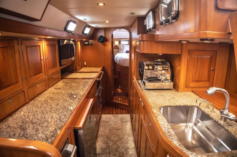 Slide: The Image of Luxurious 2012 Hylas 56 yacht interior with wood cabinetry and granite countertops. - 22