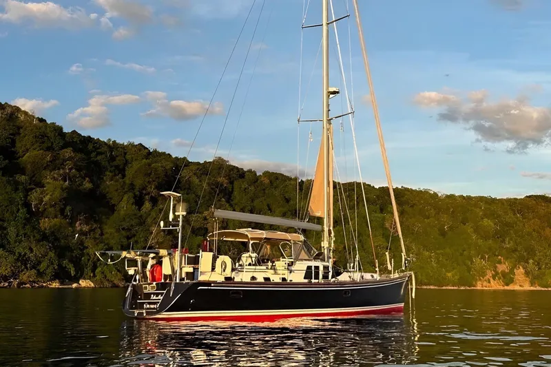 Slide: The Image of Sailing yacht Hylas 56, 2012 model, anchored in serene waters at sunset. - 3
