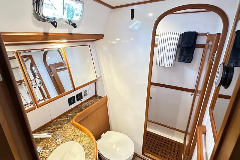 Slide: The Image of Luxurious bathroom interior of a 2012 Hylas 56 yacht, featuring wood accents and modern fixtures. - 31