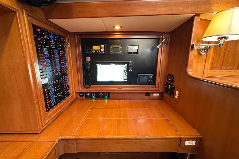 Slide: The Image of Navigation station of a 2012 Hylas 56 yacht with control panels and communication equipment. - 32