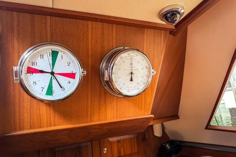 Slide: The Image of Wall-mounted clock and barometer on a 2012 Hylas 56 yacht interior. - 35