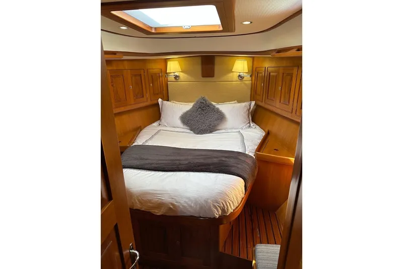 Slide: The Image of Luxurious cabin interior of 2012 Hylas 56 yacht with cozy bedding and wooden accents. - 39