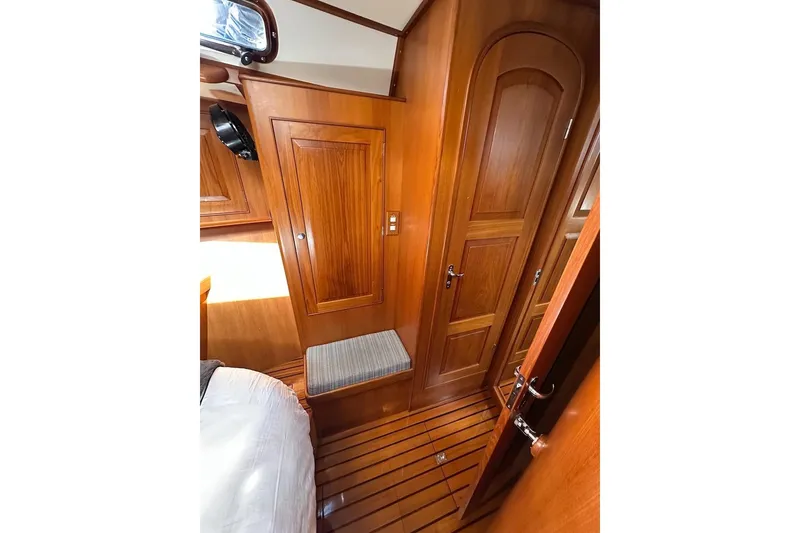 Slide: The Image of Luxurious wooden interior of 2012 Hylas 56 yacht cabin with elegant cabinetry and seating. - 41