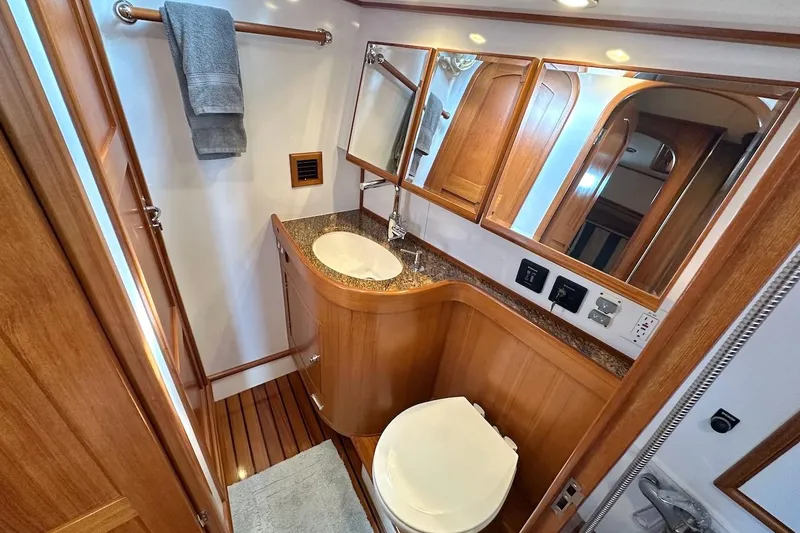 Slide: The Image of Luxurious 2012 Hylas 56 yacht bathroom with wooden cabinetry and modern fixtures. - 43